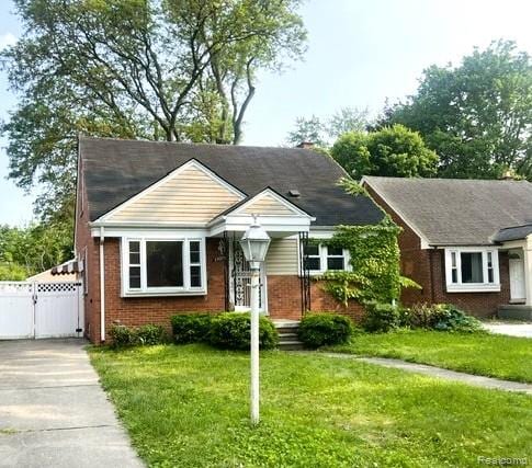 25695 Orchard Dr, Dearborn Heights, MI 48125 - view of front of house with a gate and brick siding