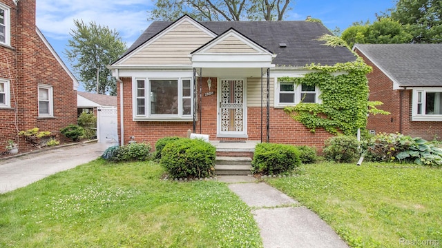 25695 Orchard Dr, Dearborn Heights, MI 48125 - bungalow with a front yard and brick siding