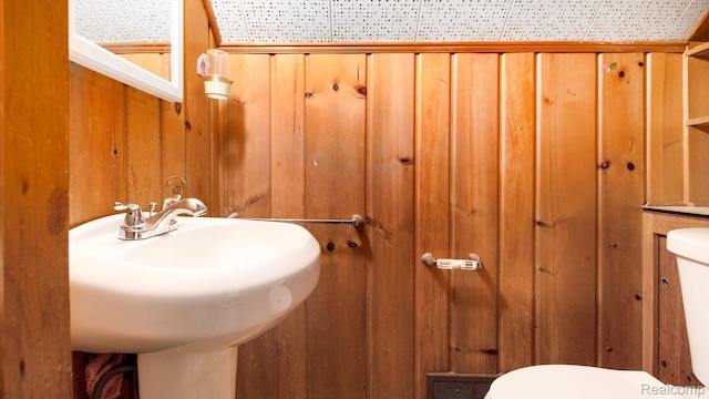 25695 Orchard Dr, Dearborn Heights, MI 48125 - bathroom with toilet and wood walls