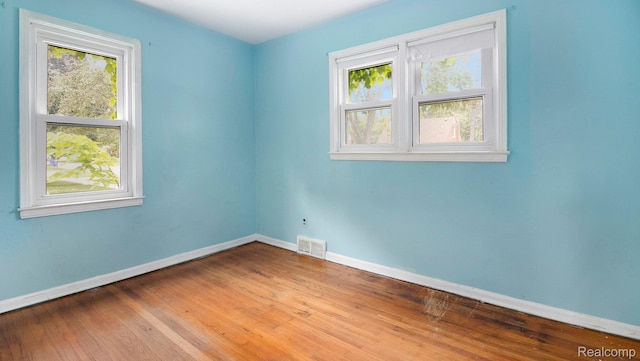25695 Orchard Dr, Dearborn Heights, MI 48125 - spare room featuring plenty of natural light and wood finished floors