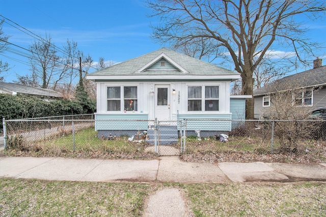 1527 Madison St, Muskegon, MI 49442 - view of front of house featuring a gate, a fenced front yard, and a shingled roof