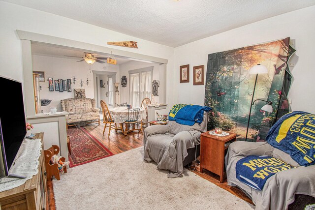 1527 Madison St, Muskegon, MI 49442 - living room with wood finished floors, a ceiling fan, and a textured ceiling