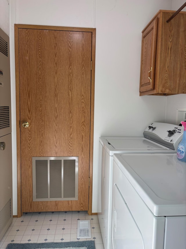 530 N June Dr, Mears, MI 49436 - laundry room with washer and dryer, cabinet space, light flooring, and a heating unit