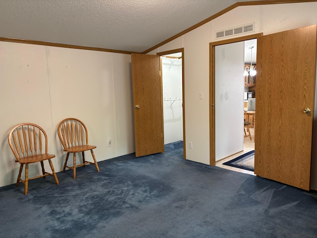 530 N June Dr, Mears, MI 49436 - living area with vaulted ceiling, carpet floors, crown molding, and a textured ceiling