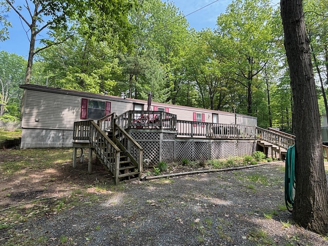 530 N June Dr, Mears, MI 49436 - rear view of property with a deck and stairway