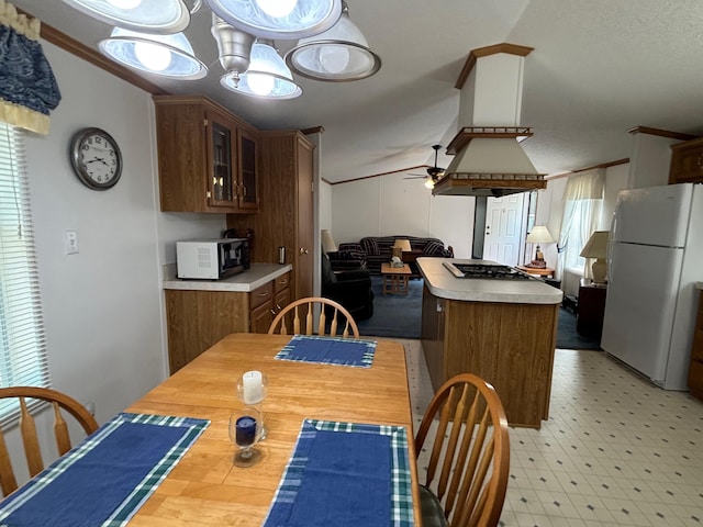 530 N June Dr, Mears, MI 49436 - dining room with ceiling fan, vaulted ceiling, light flooring, and crown molding