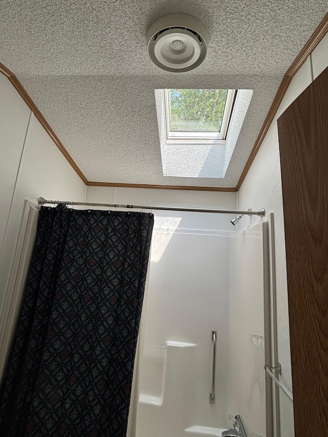 530 N June Dr, Mears, MI 49436 - bathroom with ornamental molding, vaulted ceiling, curtained shower, a skylight, and a textured ceiling