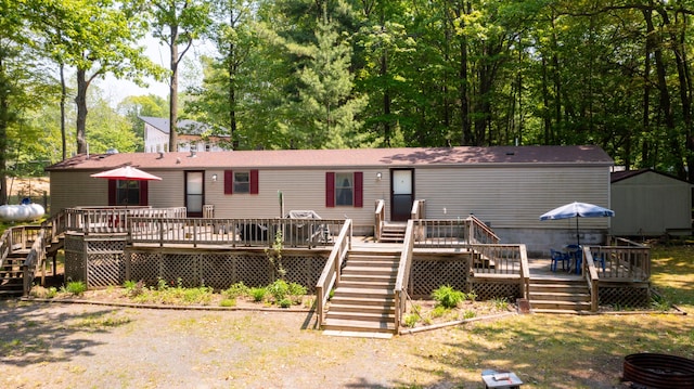 530 N June Dr, Mears, MI 49436 - view of front of home with stairway and a wooden deck