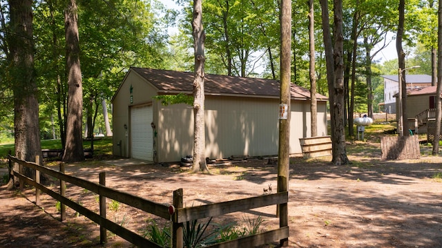 530 N June Dr, Mears, MI 49436 - wooden terrace featuring an outdoor structure, a garage, and driveway