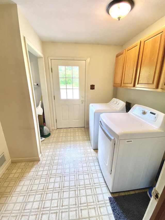 3561 Barber Rd, Hastings, MI 49058 - laundry area with cabinet space, washer and clothes dryer, baseboards, and light flooring