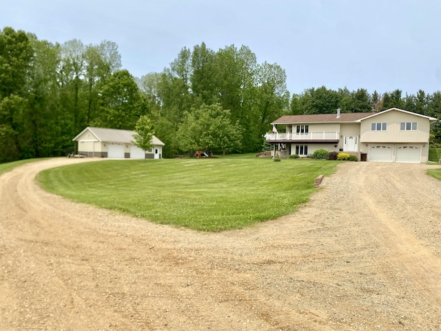 3561 Barber Rd, Hastings, MI 49058 - view of front of home featuring driveway, a front lawn, an attached garage, and view of scattered trees