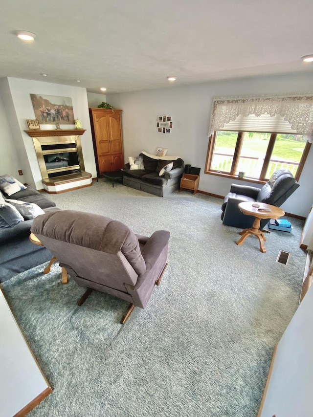 3561 Barber Rd, Hastings, MI 49058 - living room with carpet floors, recessed lighting, a glass covered fireplace, and baseboards