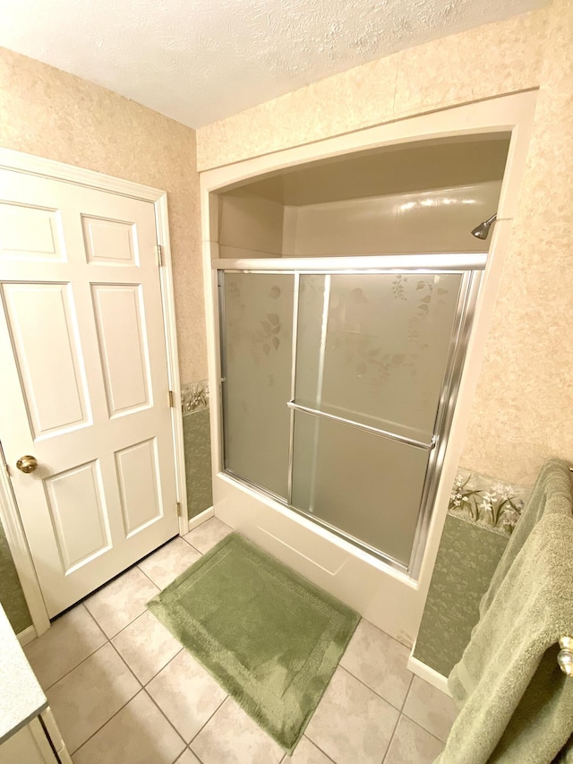 3561 Barber Rd, Hastings, MI 49058 - full bath with tile patterned floors, a textured ceiling, and enclosed tub / shower combo