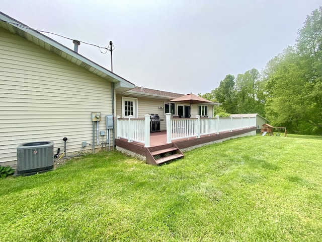 3561 Barber Rd, Hastings, MI 49058 - rear view of property featuring central AC, a wooden deck, and a lawn