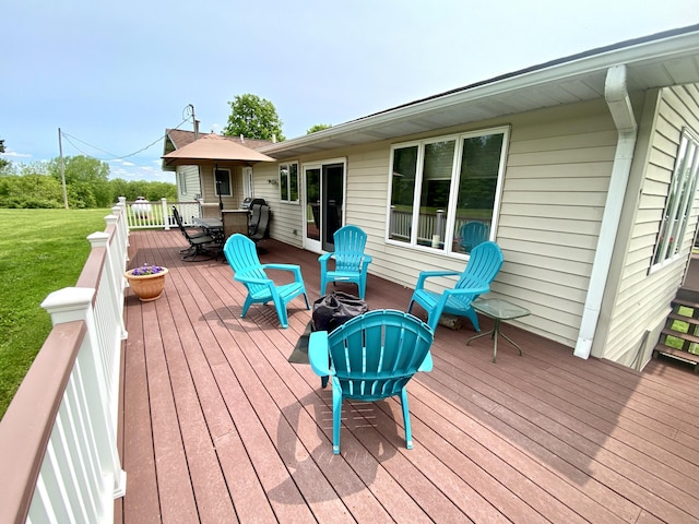 3561 Barber Rd, Hastings, MI 49058 - wooden terrace with outdoor dining area and a lawn