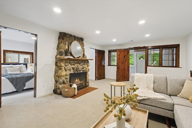 6780 Packer Dr NE, Belmont, MI 49306 - living room with recessed lighting, light carpet, a stone fireplace, and baseboards