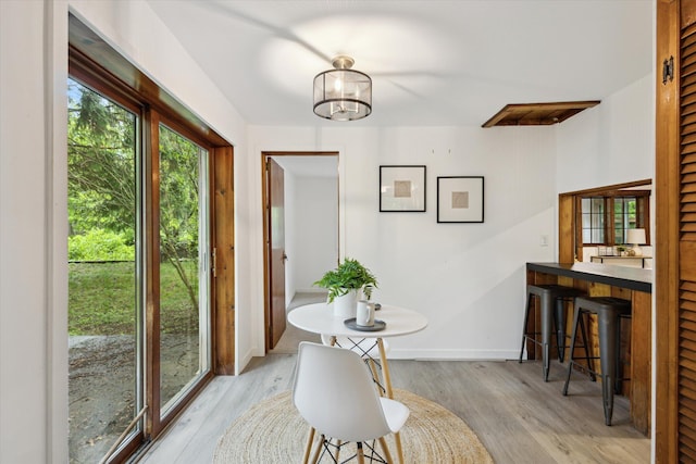 6780 Packer Dr NE, Belmont, MI 49306 - dining area featuring light wood finished floors, baseboards, and a chandelier