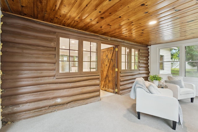 6780 Packer Dr NE, Belmont, MI 49306 - sitting room with log walls, carpet flooring, and wooden ceiling