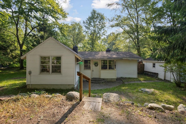 6780 Packer Dr NE, Belmont, MI 49306 - bungalow-style home with entry steps, a chimney, and a front yard