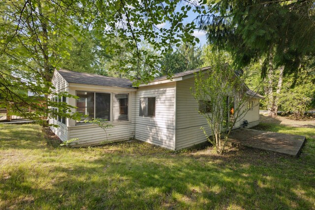 6780 Packer Dr NE, Belmont, MI 49306 - view of property exterior with a yard and a shingled roof