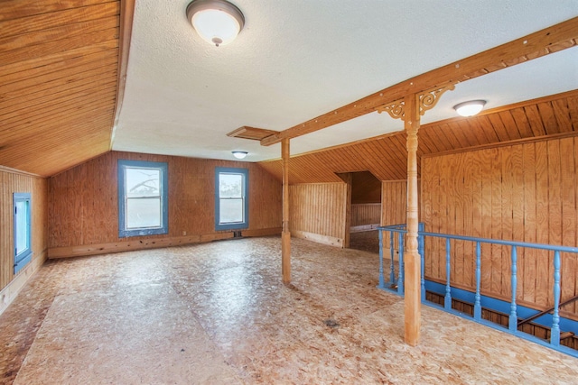 66546 Birch Rd, Jones, MI 49061 - additional living space featuring wooden walls, vaulted ceiling, and a textured ceiling
