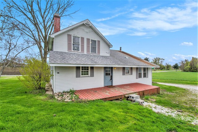 66546 Birch Rd, Jones, MI 49061 - view of front of home featuring roof with shingles, a chimney, a front lawn, and a wooden deck