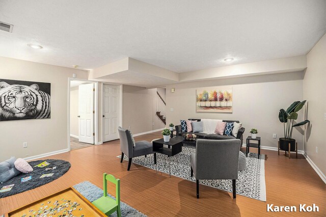240 Pettis Ave NE, Ada, MI 49301 - living area featuring stairway, light wood finished floors, baseboards, and recessed lighting