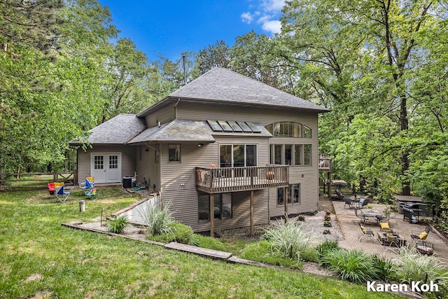 240 Pettis Ave NE, Ada, MI 49301 - rear view of property featuring a patio, a yard, and roof with shingles