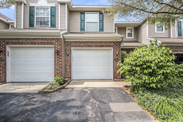 5923 E Lyn Haven Dr SE Unit 45, Grand Rapids, MI 49512 - view of front of home featuring an attached garage, brick siding, and driveway