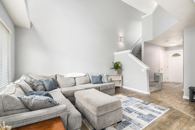 5923 E Lyn Haven Dr SE Unit 45, Grand Rapids, MI 49512 - living room featuring wood finished floors, stairs, baseboards, and a high ceiling