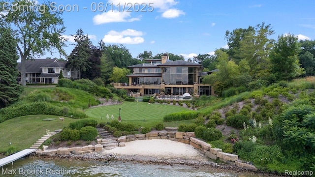 4790 Dow Ridge Rd, Orchard Lake, MI 48324 - back of house featuring a chimney and a yard