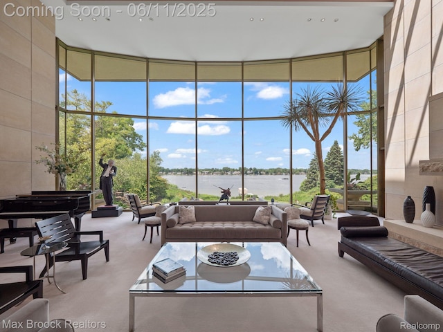 4790 Dow Ridge Rd, Orchard Lake, MI 48324 - living area with expansive windows, carpet, a high ceiling, a water view, and healthy amount of natural light