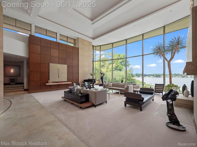 4790 Dow Ridge Rd, Orchard Lake, MI 48324 - living room featuring a high ceiling, floor to ceiling windows, a water view, and light tile patterned floors