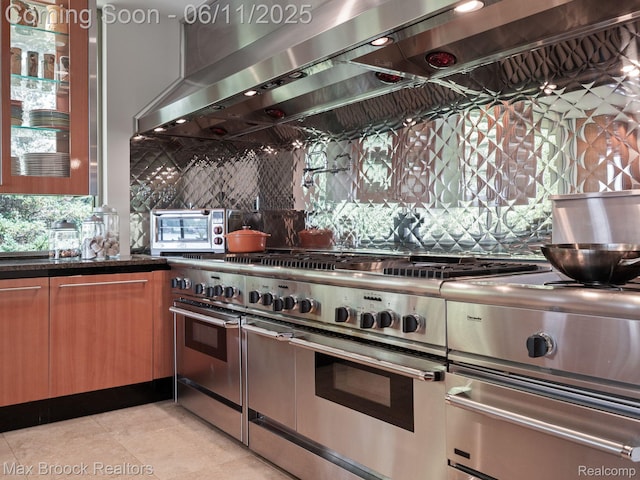 4790 Dow Ridge Rd, Orchard Lake, MI 48324 - kitchen featuring double oven range, tasteful backsplash, extractor fan, glass insert cabinets, and dark stone counters