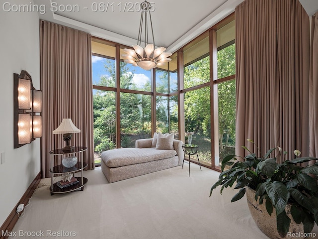4790 Dow Ridge Rd, Orchard Lake, MI 48324 - living area with a chandelier, carpet, and baseboards