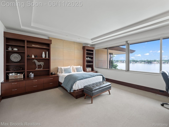 4790 Dow Ridge Rd, Orchard Lake, MI 48324 - bedroom featuring light colored carpet, multiple windows, a water view, and a raised ceiling
