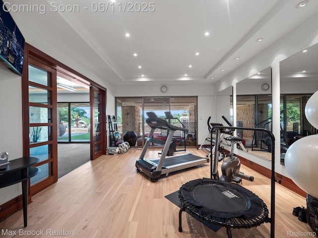 4790 Dow Ridge Rd, Orchard Lake, MI 48324 - exercise area featuring a tray ceiling, light wood-type flooring, and recessed lighting