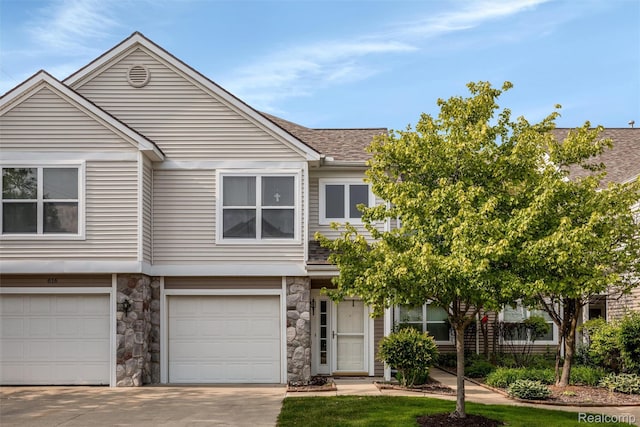 612 Riverstone Ln Unit 75, Chelsea, MI 48118 - multi unit property with concrete driveway, stone siding, a garage, and a shingled roof