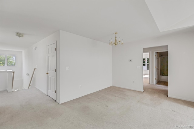 612 Riverstone Ln Unit 75, Chelsea, MI 48118 - empty room featuring light colored carpet, a chandelier, and baseboards