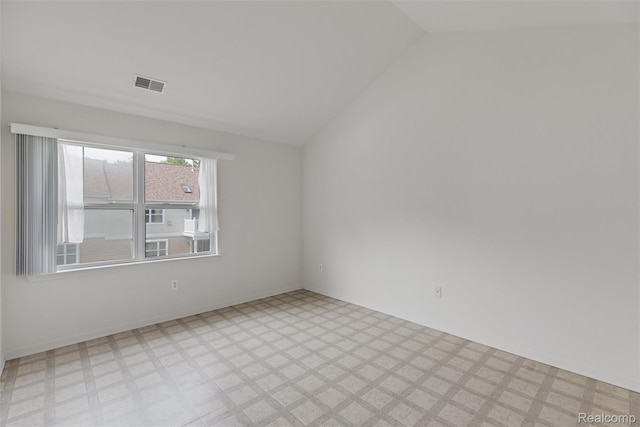 612 Riverstone Ln Unit 75, Chelsea, MI 48118 - empty room with light flooring and vaulted ceiling