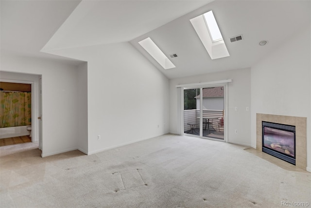612 Riverstone Ln Unit 75, Chelsea, MI 48118 - unfurnished living room featuring a fireplace, carpet, vaulted ceiling, a skylight, and baseboards