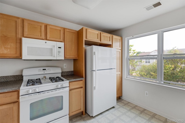 612 Riverstone Ln Unit 75, Chelsea, MI 48118 - kitchen with white appliances, light flooring, dark countertops, and baseboards