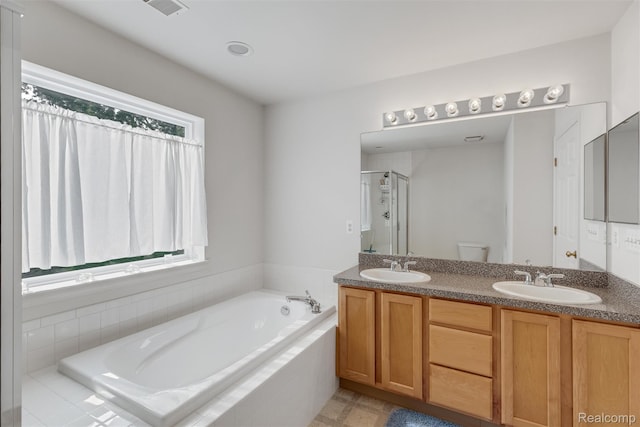 612 Riverstone Ln Unit 75, Chelsea, MI 48118 - bathroom with a bath, double vanity, a shower stall, and toilet
