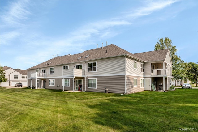 612 Riverstone Ln Unit 75, Chelsea, MI 48118 - rear view of house with a balcony, a yard, and roof with shingles