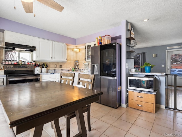9636 Mueller St, Taylor, MI 48180 - dining space featuring a textured ceiling, light tile patterned floors, and a ceiling fan