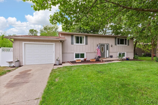 311 Marion St, Clinton, MI 49236 - split foyer home featuring concrete driveway and an attached garage
