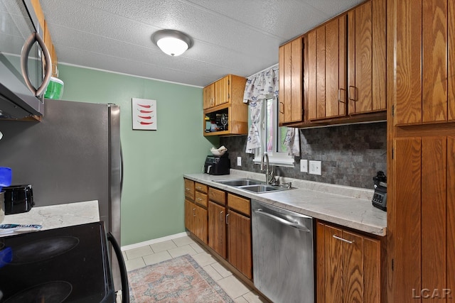 311 Marion St, Clinton, MI 49236 - kitchen featuring stainless steel appliances, a sink, brown cabinetry, and tasteful backsplash