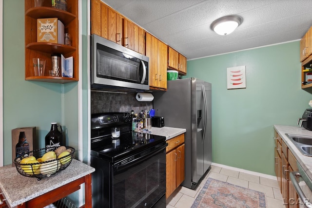 311 Marion St, Clinton, MI 49236 - kitchen featuring stainless steel appliances, brown cabinetry, and light countertops