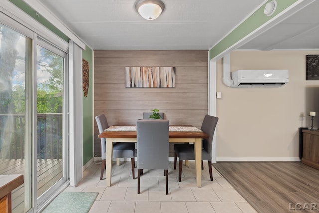 311 Marion St, Clinton, MI 49236 - tiled dining room featuring a wall unit AC, wooden walls, and baseboards