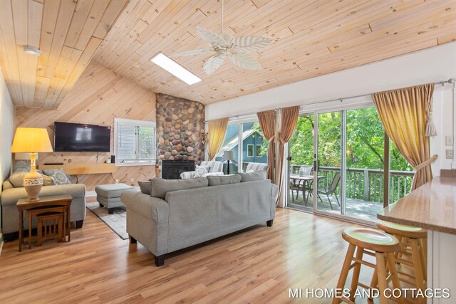 2338 Crescent Walk, Macatawa, MI 49434 - living area with wooden ceiling, wood walls, lofted ceiling, a ceiling fan, and light wood-type flooring